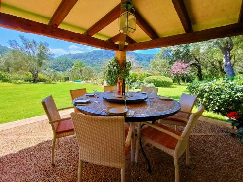 einen Tisch und Stühle auf einer Terrasse mit Aussicht in der Unterkunft Sa Tafona de Son Quint en Esporles in Esporles