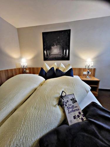 a bedroom with a large bed with a sign on it at Lebensquelle Krapfenhof in Finkenberg