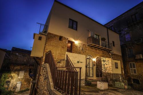 an old building with a staircase leading up to it at night at Casa Lerux in Agrigento