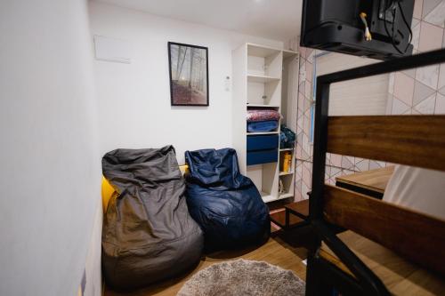 a room with two sleeping bags next to a bed at Minicasa Brasileira in Sorocaba