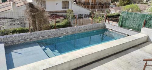a swimming pool on top of a building at La Casita del Arroyo in Arroyo Frio