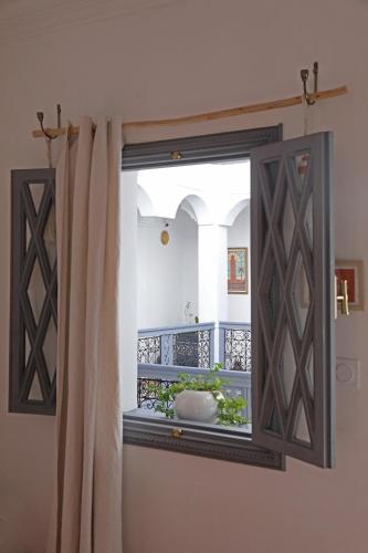 a bathroom with a window with a sink on a balcony at Riad Amya & Spa in Marrakech