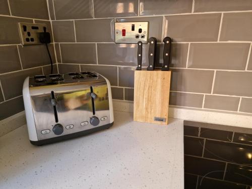 a kitchen counter with a stove and a knife block at Cromer Crab Shack in Cromer