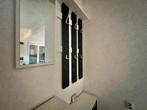 a mirror on the wall of a bathroom with a sink at Vamos a la playa - Djenovici in Ðenovići