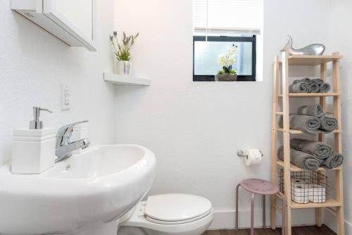a bathroom with a white sink and a toilet at Lovely Apartment Near Brickell 1 in Miami