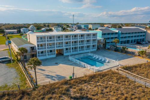 an aerial view of a large building with a swimming pool at The Sand Dunes in Kure Beach