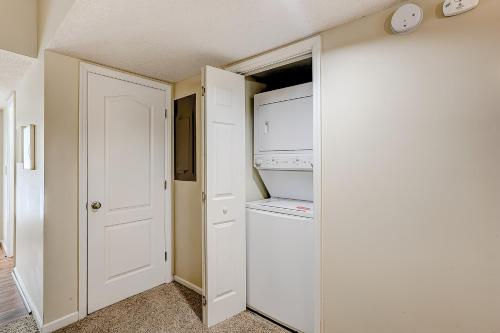 a small kitchen with a refrigerator and a washer and dryer at Egrets Pointe, Unit 492 in Edisto Island