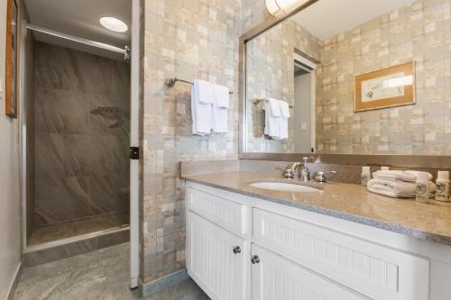 a bathroom with a sink and a shower at Paki Maui Condos in Honokowai