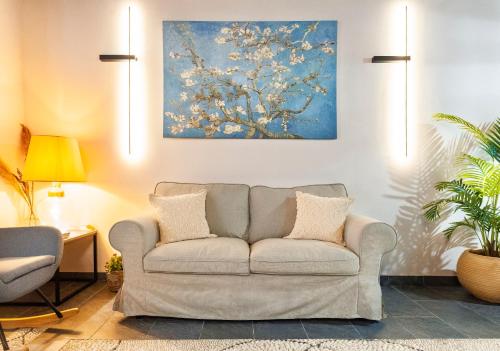 a living room with a couch and a painting at Mandorla Apartments in Rhodes Town