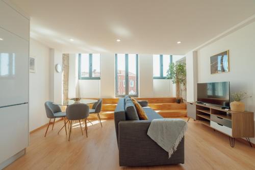 a living room with a couch and a table at Modern & Stylish Apartments by Vacationy in Porto