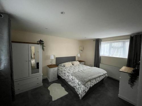 a bedroom with a bed and a dresser and a mirror at The Stag 