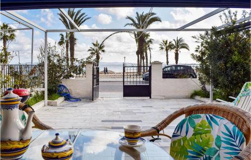 a glass table with a view of the beach at Beautiful Home In Los Alcázares in Los Narejos