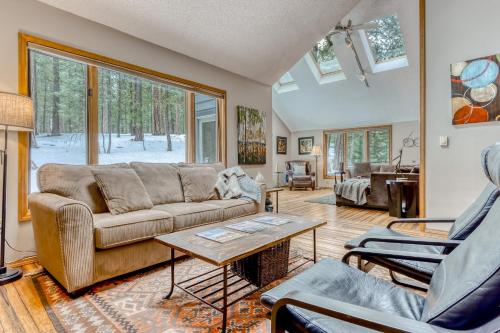 a living room with a couch and a table at Black Butte Gem in Black Butte Ranch