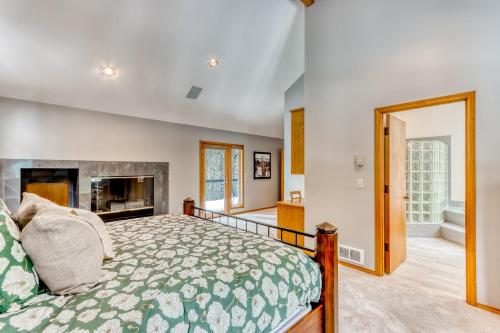 a bedroom with a bed and a fireplace at Black Butte Gem in Black Butte Ranch