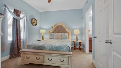 a bedroom with a bed with a wooden headboard at Laketown Wharf #113 by Nautical Properties in Panama City Beach