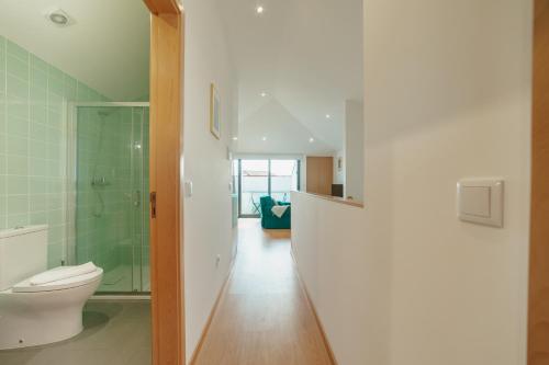 a bathroom with a toilet and a glass shower at Modern & Stylish Apartments by Vacationy in Porto