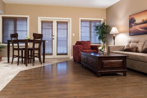 a living room with a couch and a table and chairs at The Castle at Swan Lake in Vernon