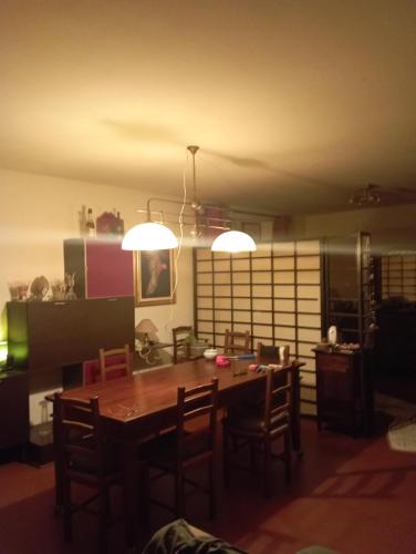 a dining room with a table and chairs and lights at Monferrato Inn in Rivarone