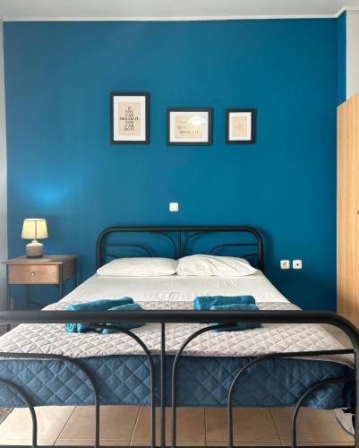 a blue bedroom with a bed with a blue wall at Αγκυροβόλιο in Ilia