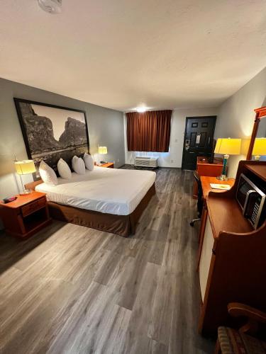 a large hotel room with a bed and a desk at Super 8 by Wyndham Sealy in Sealy