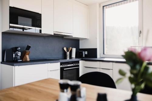 a kitchen with white cabinets and a stove top oven at Ferienhaus Sandra in Hörbranz