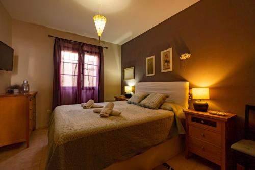 a bedroom with a bed with two towels on it at Casa Zora in Agaete