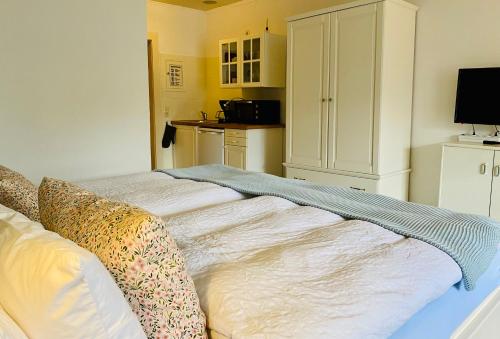 a bedroom with a bed with pillows on it at Kajüthus Apartment 6 in Fehmarn