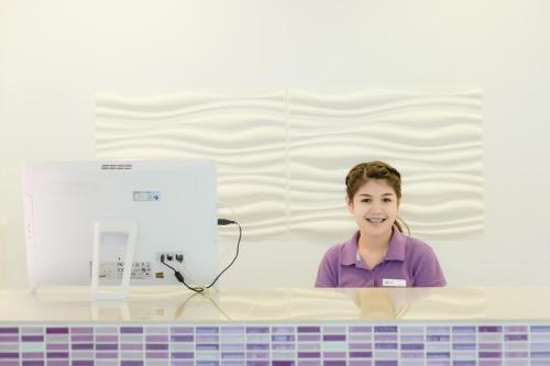 a young girl sitting at a counter with a computer at Z by Zing in Jomtien Beach