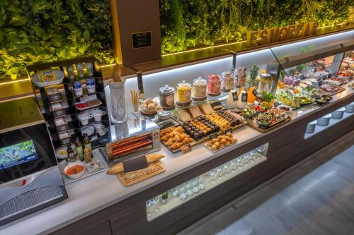 a buffet line with food on display in a restaurant at SERHS Carlit Boutique Hotel in Barcelona