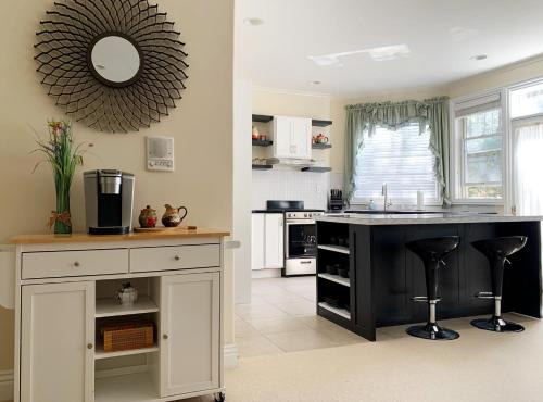 a kitchen with a black counter and a sink at Little Paradise with Sauna Garden near Downtown in Saratoga