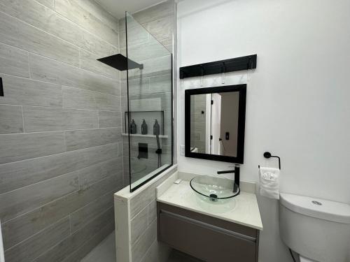 a bathroom with a sink and a shower and a toilet at Antigua chiama Italia villas in Jolly Harbour