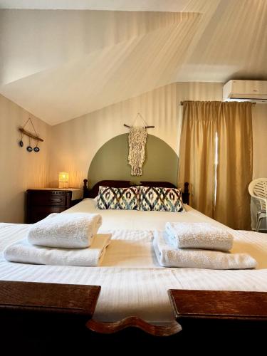 a bedroom with a large bed with two pillows at Villa Merci Budva in Budva