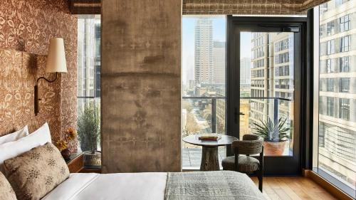 a bedroom with a bed and a large window at Austin Proper Hotel, a Member of Design Hotels in Austin