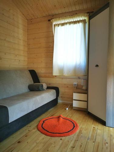 a bedroom with a bed and a large window at Rio Park domki letniskowe Łukęcin in Łukęcin