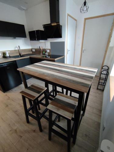a kitchen with a large wooden table and chairs at Résidence Manivi in Beaupréau