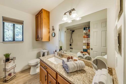 a bathroom with a sink and a toilet and a mirror at Wildlife Watching and Mtn Views Luxe Ruidoso Escape in Ruidoso