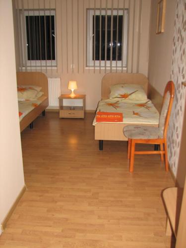 a room with a bed and a table and a lamp at Zajazd Markowski in Bojanowo