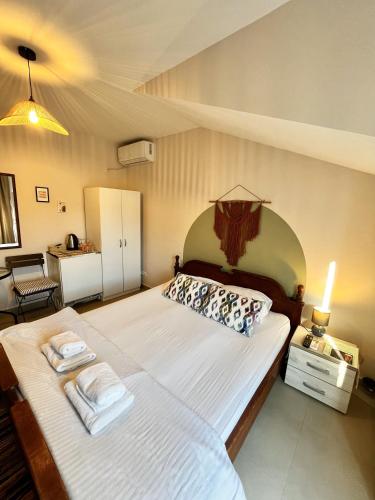 a bedroom with a large bed with towels on it at Villa Merci Budva in Budva
