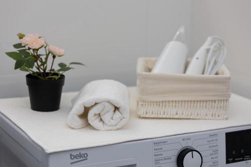 a towel sitting on top of a washing machine at Oś Królewska - Comfortable Apartment in Wilanów in Warsaw