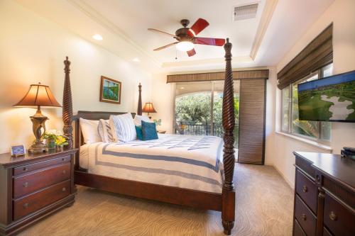 a bedroom with a bed with a ceiling fan at Mauna Lani Fairways 401 in Waikoloa