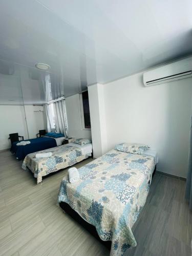 a room with two beds in a room at BLUE ISLAND HOTEL in San Andrés