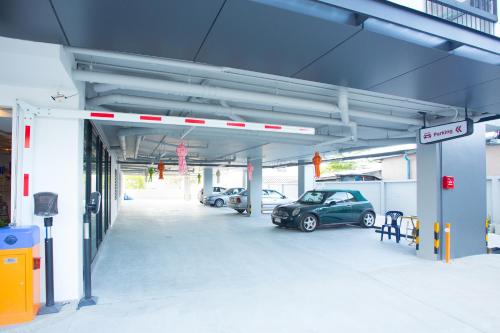 a parking garage with two cars parked in it at Vanilla Residence Chiangmai in Chiang Mai