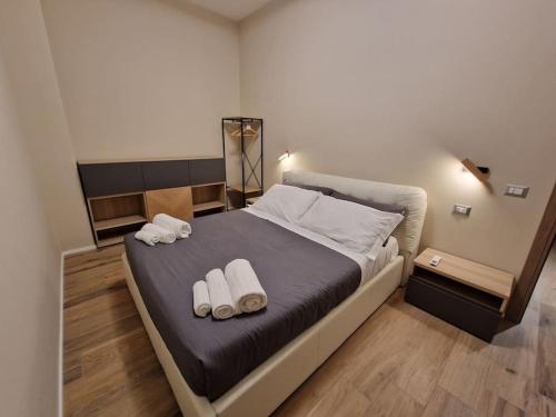 a bedroom with a bed with two towels on it at Corso Vittorio 364 in Cagliari