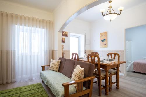 a living room with a couch and a table at casa saloia in Nazaré