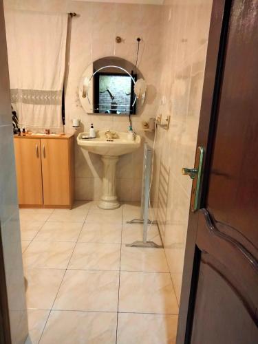 a bathroom with a sink and a mirror at Casa da Emilia do Gerês in Outeiro