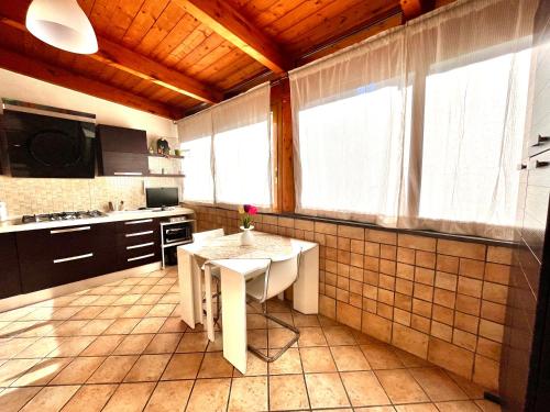 a kitchen with a table in the middle of it at Sivy Home casa vacanze Napoli in Naples