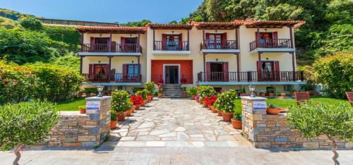 a house with a stone walkway in front of it at Pelagos Hotel in Agios Ioannis Pelio