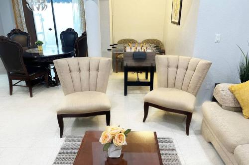 a living room with a couch and chairs and a table at Amazing & cozy Duplex near Zoo Miami ! in Miami