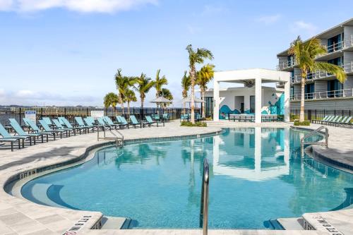 a swimming pool with lounge chairs and a resort at Villatel at Harbor Island Beach Club in Melbourne Beach
