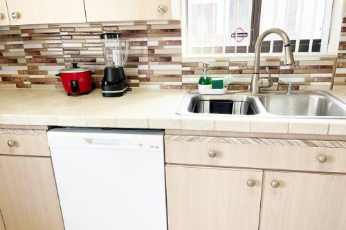 a kitchen counter with a sink and a mixer at Amazing & cozy Duplex near Zoo Miami ! in Miami